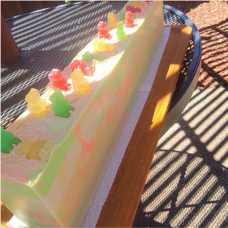 Translucent candy-colored bar with a playful gummy bear swirl